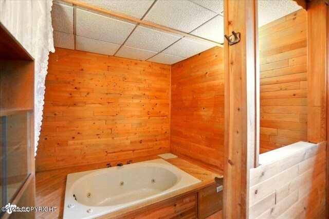 24508 Reese Rd, Chugiak, AK 99567 - full bath with a jetted tub, wood walls, and a paneled ceiling