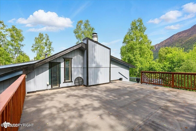 24508 Reese Rd, Chugiak, AK 99567 - view of side of home with a chimney and a mountain view