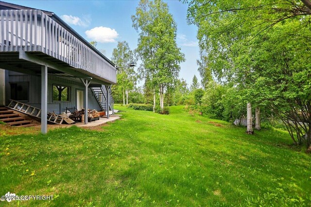 24508 Reese Rd, Chugiak, AK 99567 - view of green lawn featuring stairway and a deck