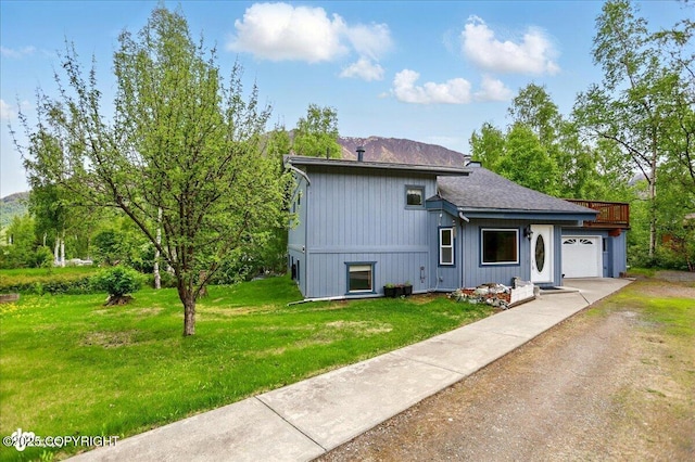 24508 Reese Rd, Chugiak, AK 99567 - split level home featuring a garage, a front lawn, driveway, and roof with shingles