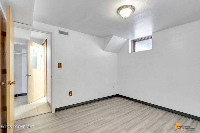 interior space featuring visible vents, baseboards, and wood finished floors