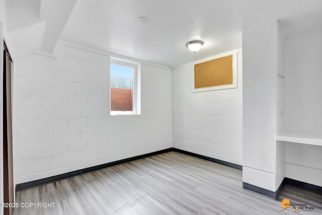 empty room with baseboards and wood finished floors