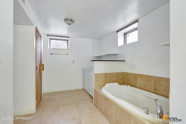 bathroom with tile patterned flooring, plenty of natural light, and a bath