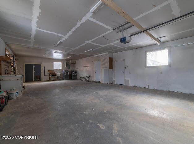 garage featuring a garage door opener and independent washer and dryer