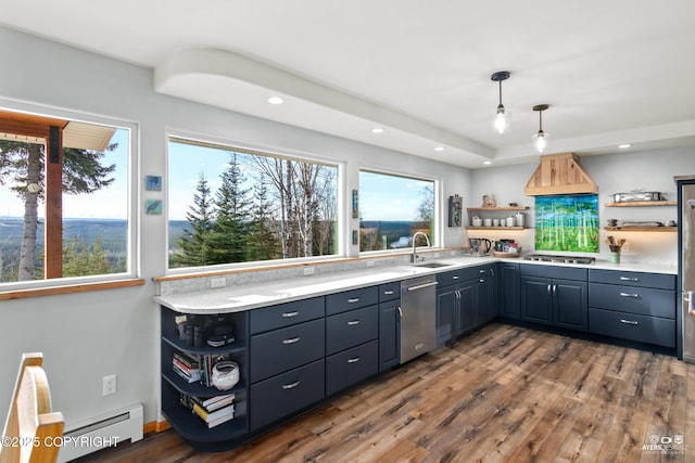 kitchen featuring open shelves, custom range hood, appliances with stainless steel finishes, and a sink