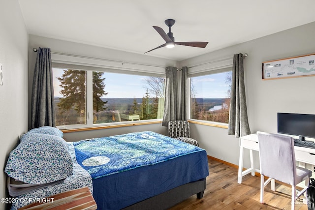 bedroom featuring a ceiling fan and wood finished floors