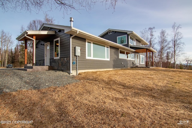 view of home's exterior featuring a yard and stone siding