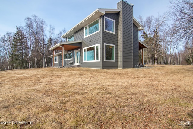 exterior space featuring a yard and a chimney