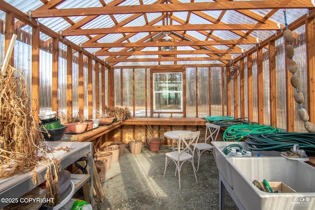 unfurnished sunroom with lofted ceiling