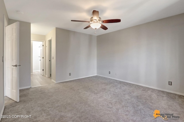 spare room with baseboards, carpet, and ceiling fan