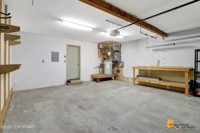 garage featuring electric panel, a workshop area, a garage door opener, and water heater