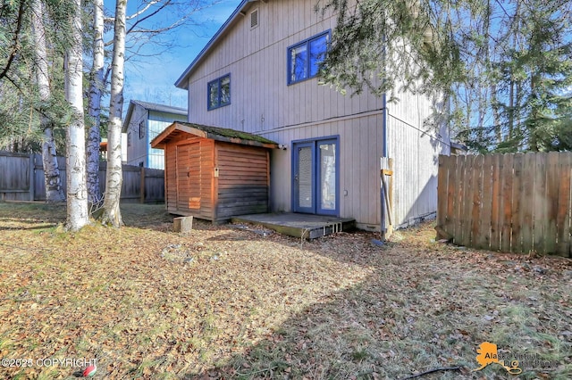 rear view of house featuring fence