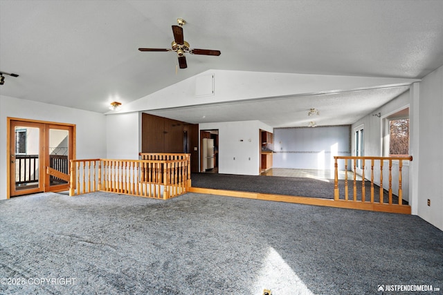 unfurnished room with lofted ceiling, a textured ceiling, ceiling fan, and carpet flooring