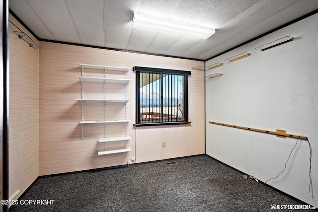 unfurnished room with visible vents and a textured ceiling