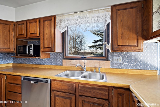 kitchen featuring a sink, tasteful backsplash, appliances with stainless steel finishes, brown cabinetry, and light countertops