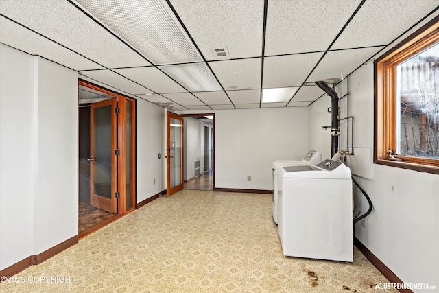 laundry area featuring visible vents, washing machine and dryer, and baseboards