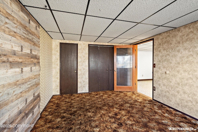 unfurnished bedroom with carpet flooring and a drop ceiling