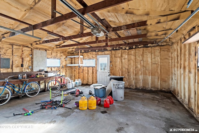 garage with electric panel and a garage door opener