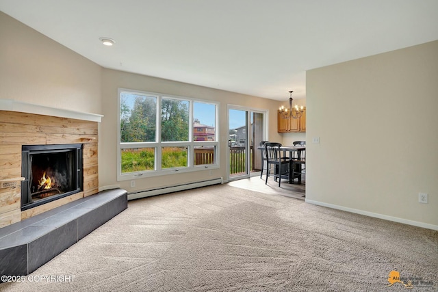 unfurnished living room with baseboards, a chandelier, carpet flooring, a fireplace, and a baseboard radiator