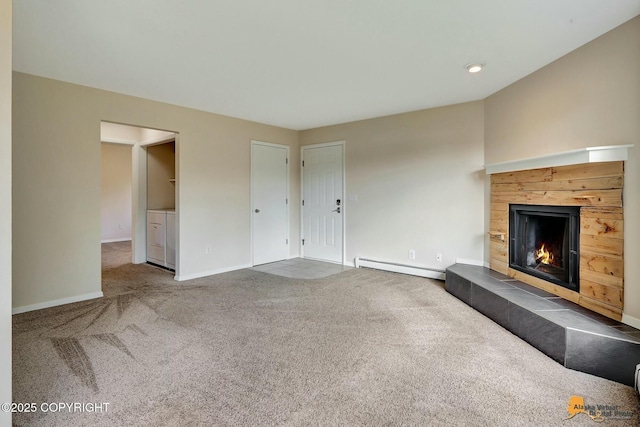 unfurnished living room featuring a baseboard radiator, baseboards, carpet, and a fireplace