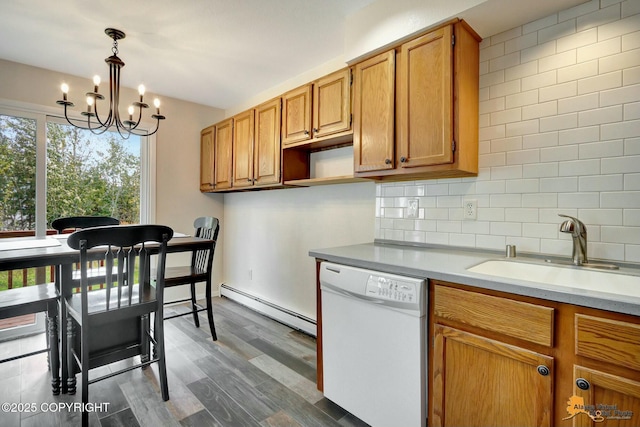 kitchen with white dishwasher, dark wood-style flooring, a sink, a baseboard heating unit, and tasteful backsplash