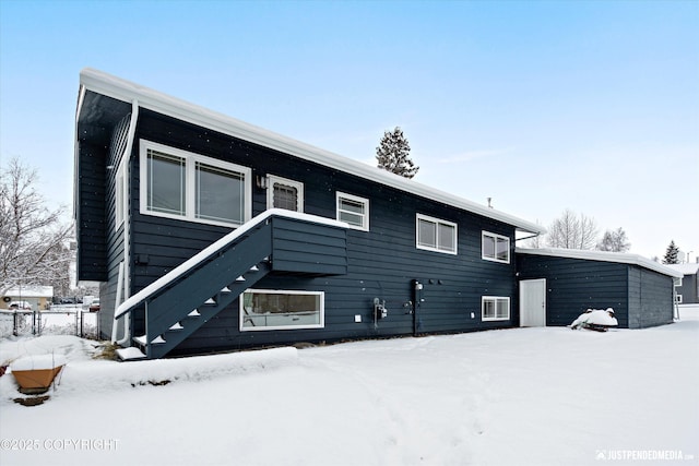 view of front of home featuring stairway and fence