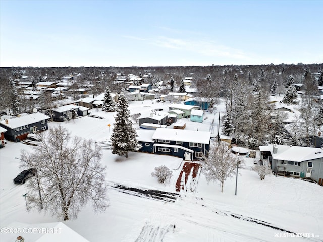 snowy aerial view featuring a residential view