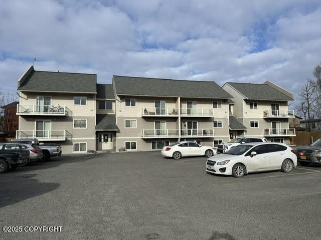 view of building exterior featuring uncovered parking