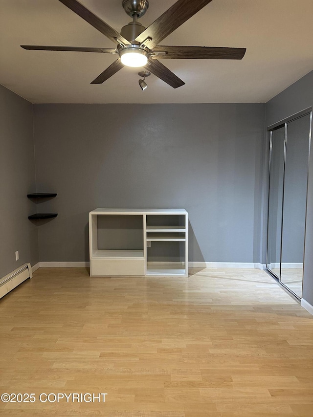 unfurnished bedroom with a closet, baseboards, a ceiling fan, and light wood finished floors