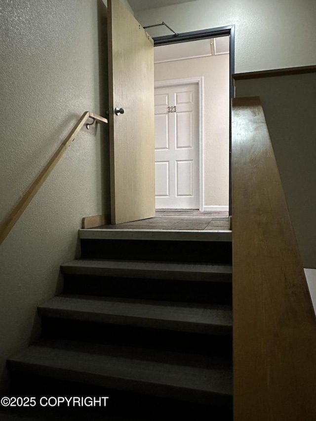 staircase with a textured wall