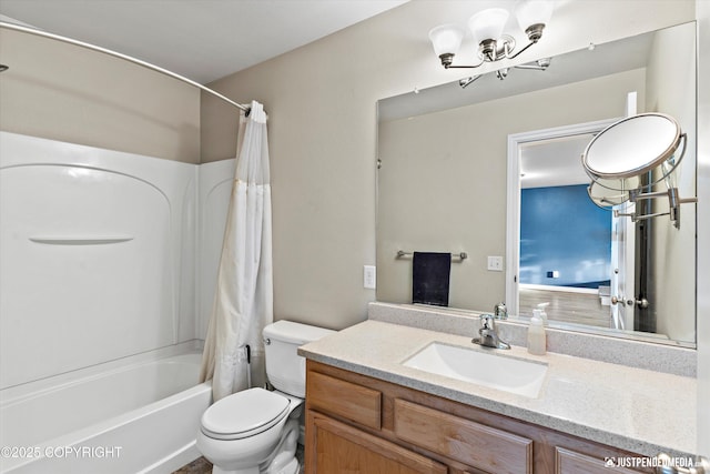 bathroom with toilet, a notable chandelier, vanity, and shower / tub combo with curtain