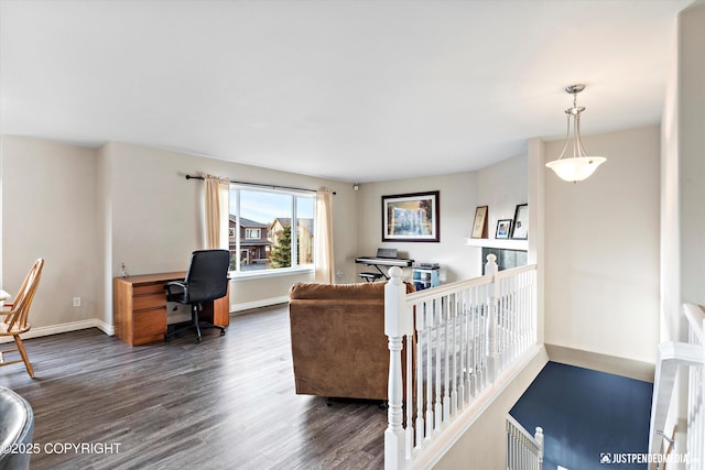 living area featuring baseboards and dark wood-style flooring