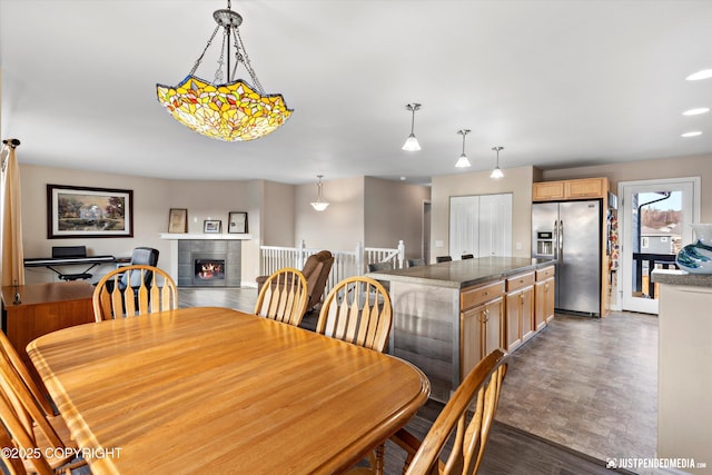 dining room featuring recessed lighting and a tiled fireplace