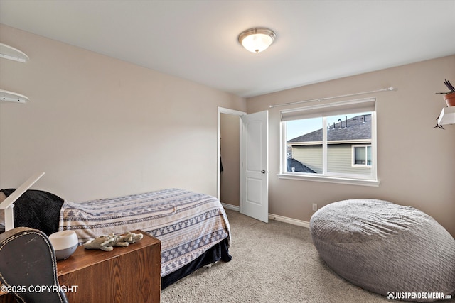 bedroom with baseboards and carpet