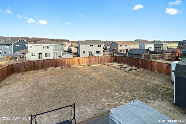 view of yard with a fenced backyard and a residential view