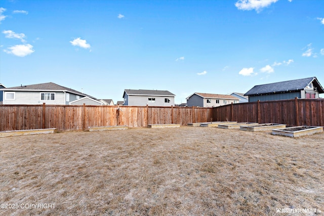 view of yard with a vegetable garden and fence