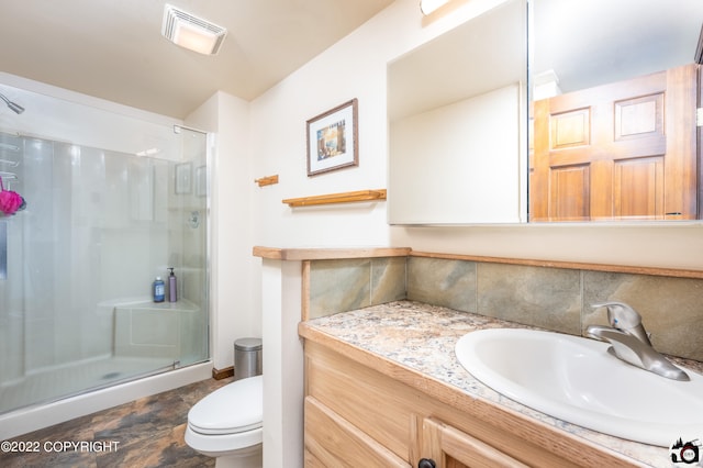 bathroom with visible vents, a stall shower, toilet, and vanity