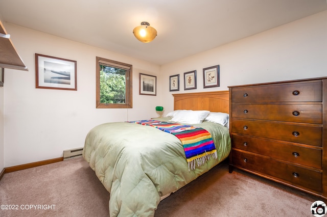 carpeted bedroom featuring baseboard heating and baseboards