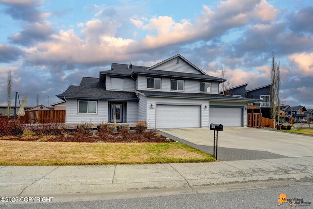 1091 Northpointe Bluff Dr, Anchorage, AK 99501 - traditional-style house with an attached garage, concrete driveway, and a shingled roof