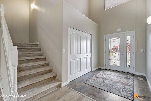1091 Northpointe Bluff Dr, Anchorage, AK 99501 - foyer featuring a high ceiling, stairs, and stone finish flooring