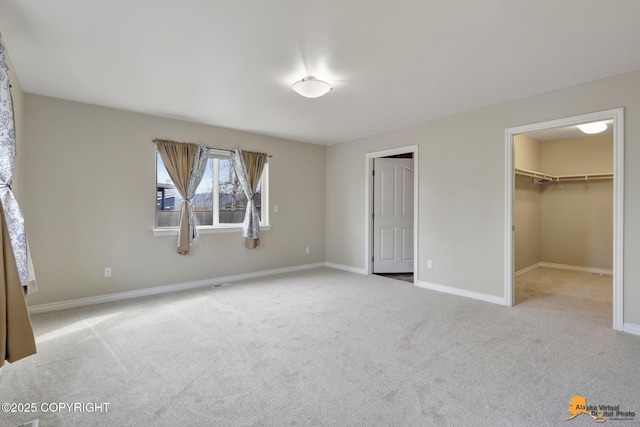 1091 Northpointe Bluff Dr, Anchorage, AK 99501 - unfurnished bedroom featuring carpet flooring, a walk in closet, and a closet