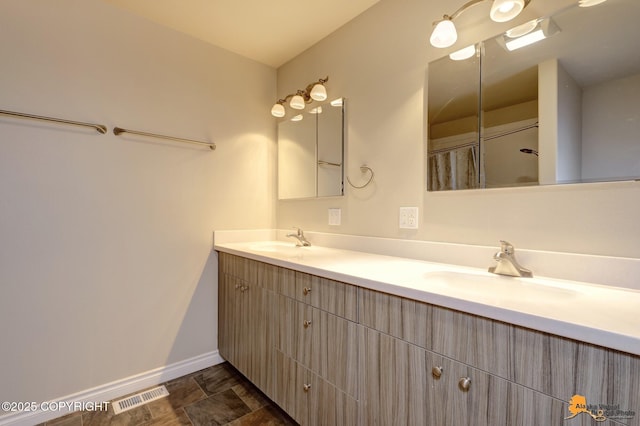 1091 Northpointe Bluff Dr, Anchorage, AK 99501 - full bathroom featuring double vanity and baseboards