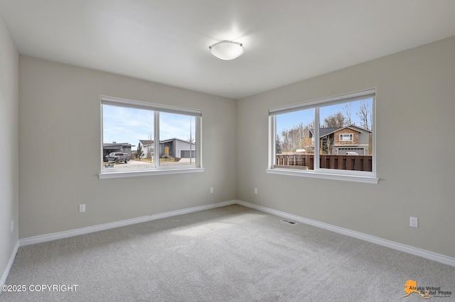 1091 Northpointe Bluff Dr, Anchorage, AK 99501 - spare room featuring carpet and baseboards