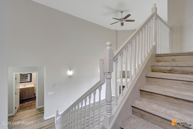 1091 Northpointe Bluff Dr, Anchorage, AK 99501 - stairway with ceiling fan and wood finished floors