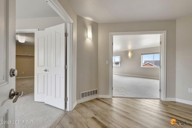 1091 Northpointe Bluff Dr, Anchorage, AK 99501 - hall with carpet and wood finished floors