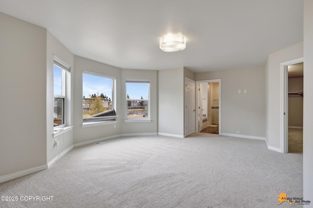 1091 Northpointe Bluff Dr, Anchorage, AK 99501 - unfurnished bedroom featuring carpet, multiple windows, and ensuite bath