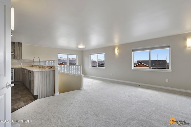 1091 Northpointe Bluff Dr, Anchorage, AK 99501 - empty room featuring a sink and dark colored carpet
