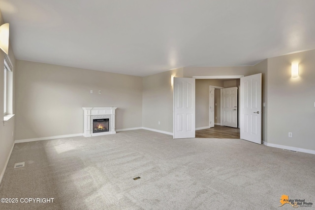 1091 Northpointe Bluff Dr, Anchorage, AK 99501 - unfurnished living room featuring carpet and a premium fireplace