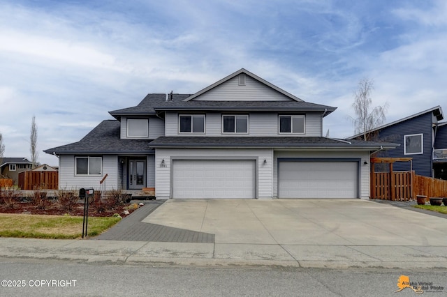 1091 Northpointe Bluff Dr, Anchorage, AK 99501 - traditional home featuring concrete driveway, an attached garage, and roof with shingles