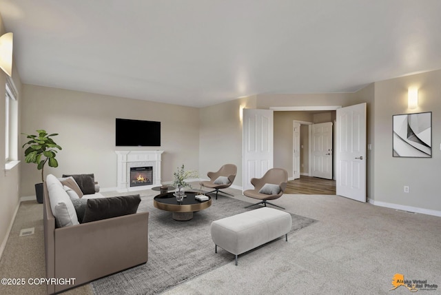 1091 Northpointe Bluff Dr, Anchorage, AK 99501 - carpeted living area featuring a glass covered fireplace and baseboards